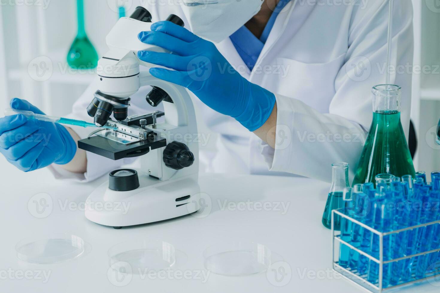 microscope with lab glassware, science laboratory research and development concept photo