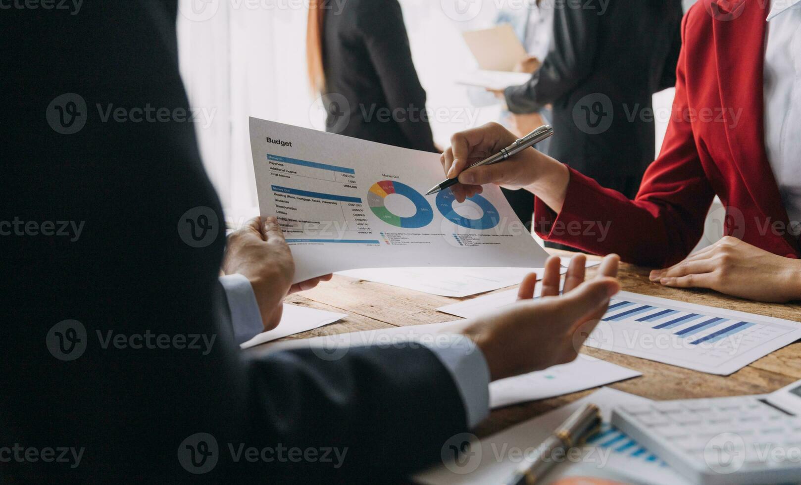 Financial analysts analyze business financial reports on a digital tablet planning investment project during a discussion at a meeting of corporate showing the results of their successful teamwork. photo