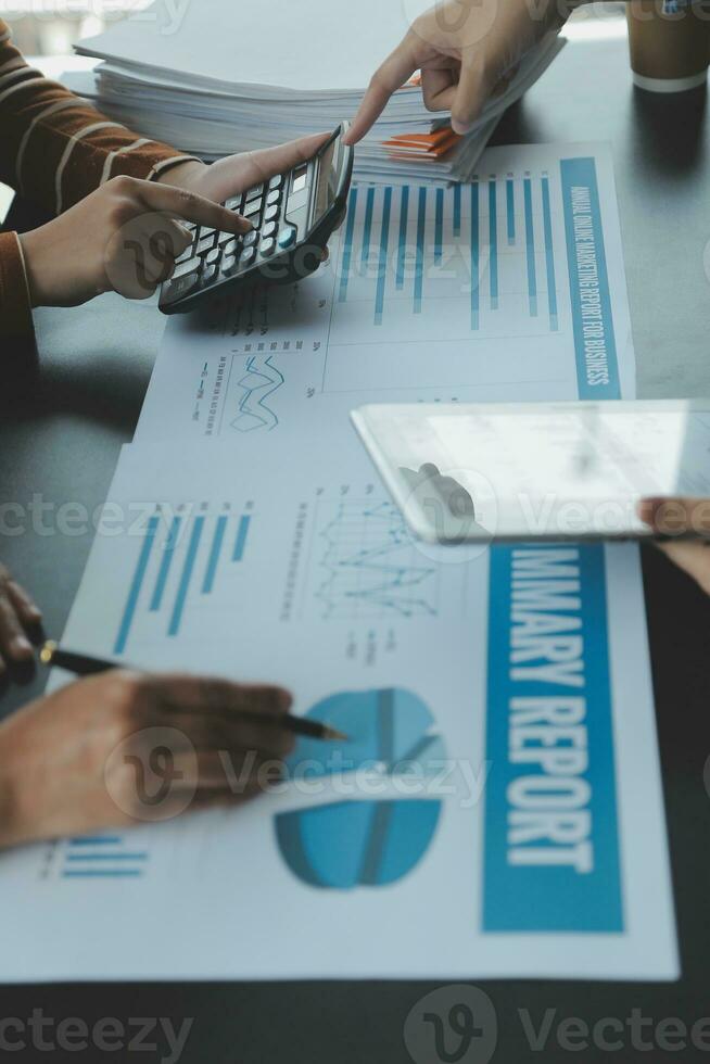 Financial analysts analyze business financial reports on a digital tablet planning investment project during a discussion at a meeting of corporate showing the results of their successful teamwork. photo