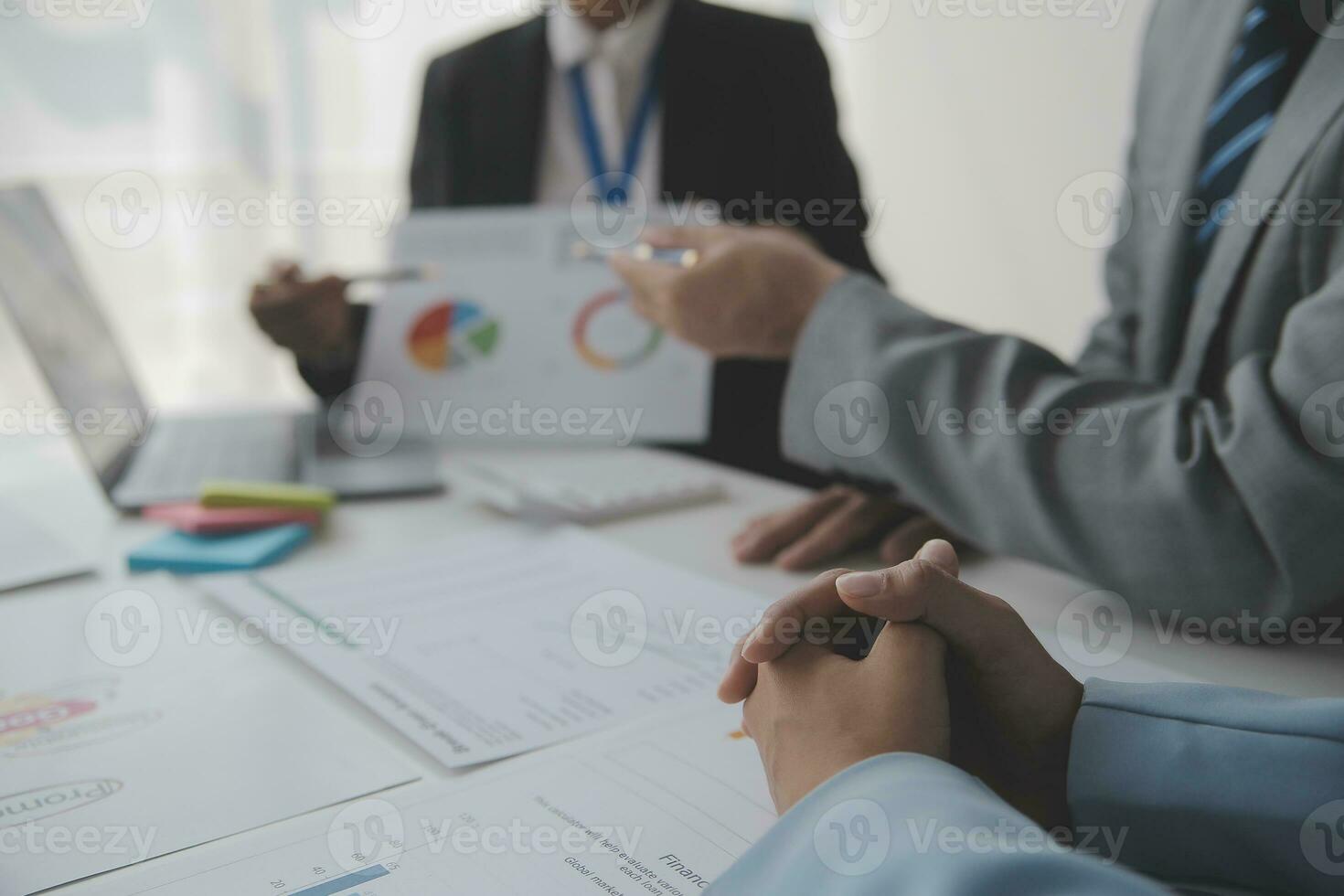Financial analysts analyze business financial reports on a digital tablet planning investment project during a discussion at a meeting of corporate showing the results of their successful teamwork. photo