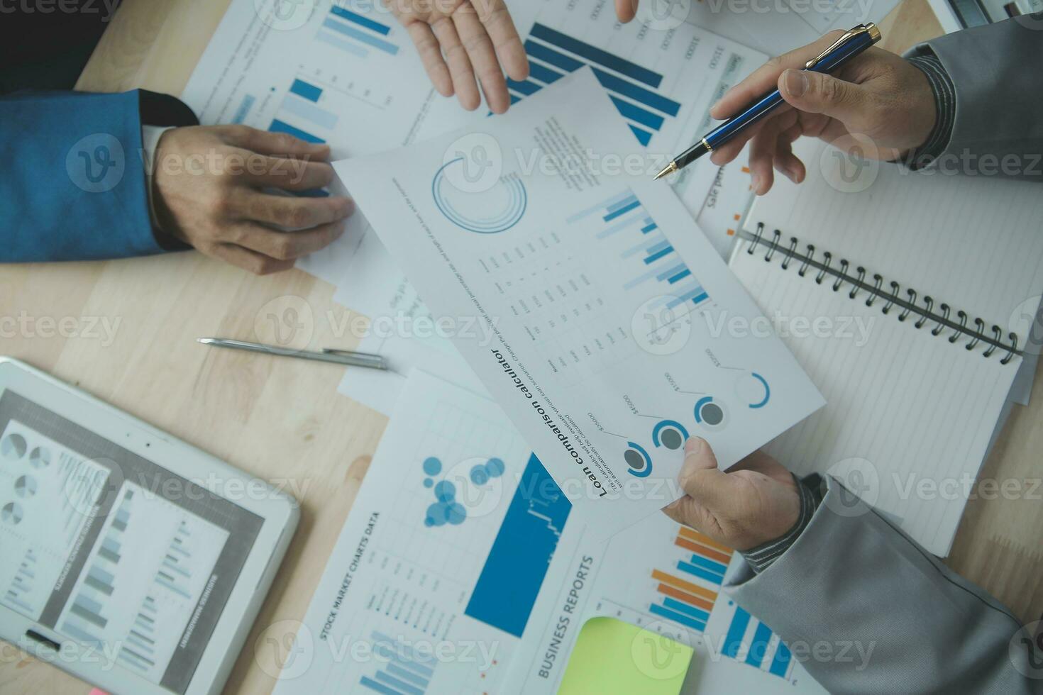Group of confident business people point to graphs and charts to analyze market data, balance sheet, account, net profit to plan new sales strategies to increase production capacity. photo