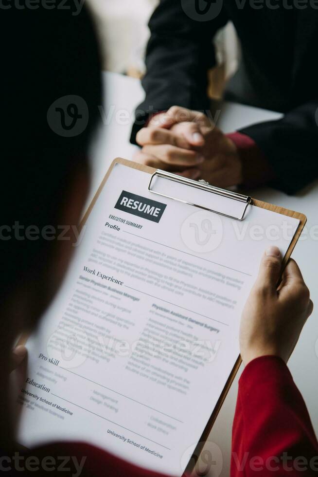 Close up view of job interview in office, focus on resume writing tips, employer reviewing good cv of prepared skilled applicant, recruiter considering application, hr manager making hiring decision photo