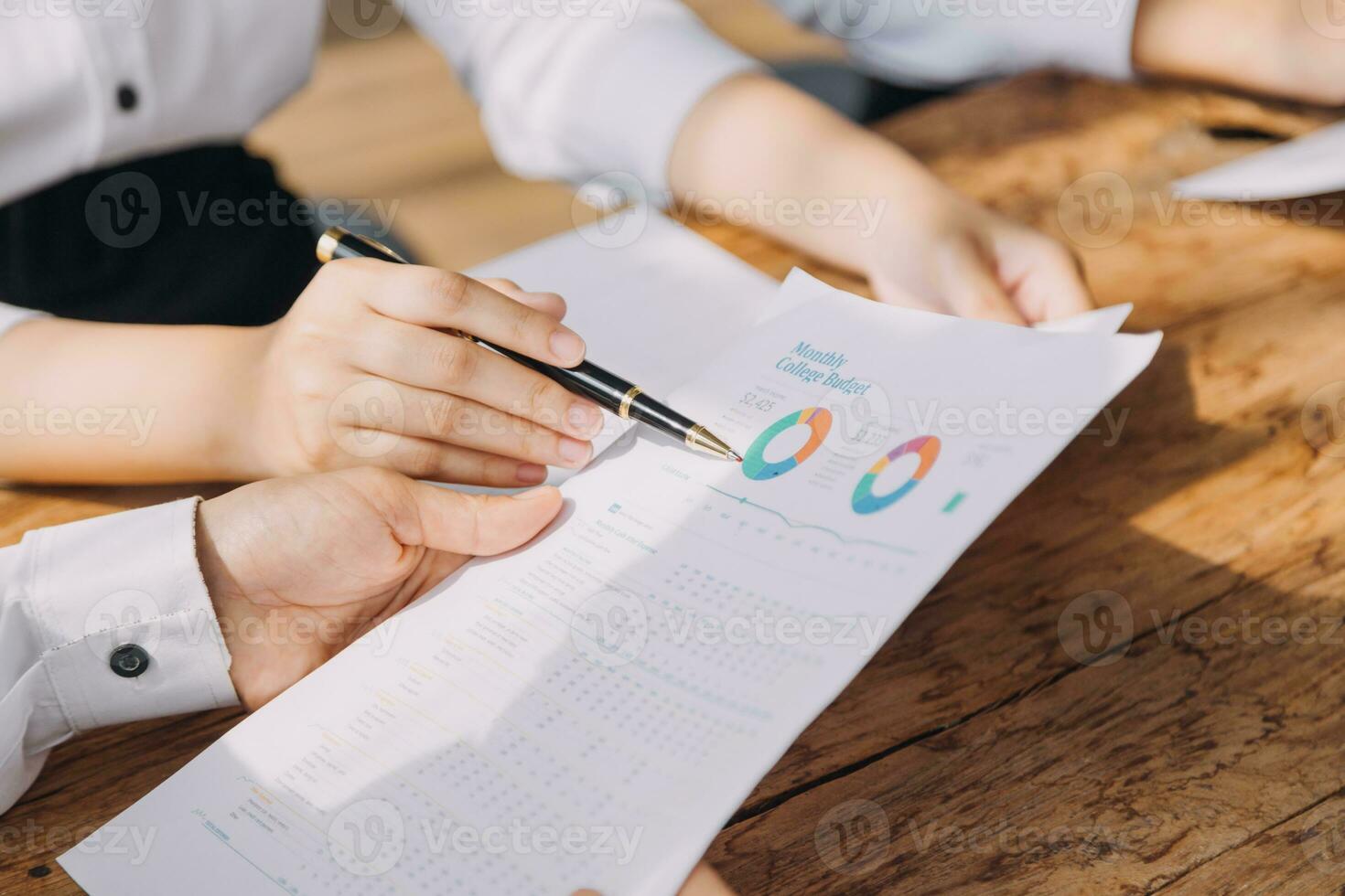 Financial analysts analyze business financial reports on a digital tablet planning investment project during a discussion at a meeting of corporate showing the results of their successful teamwork. photo