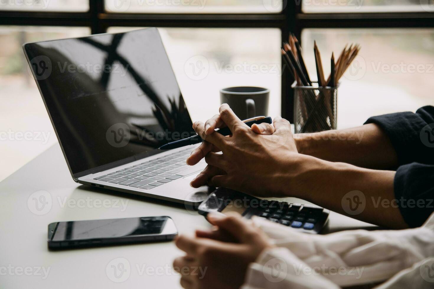 Entrepreneur Asian businessman and businesswoman discussing new business project in tablet in modern Meeting In Modern Office, Asian business casual concept. photo