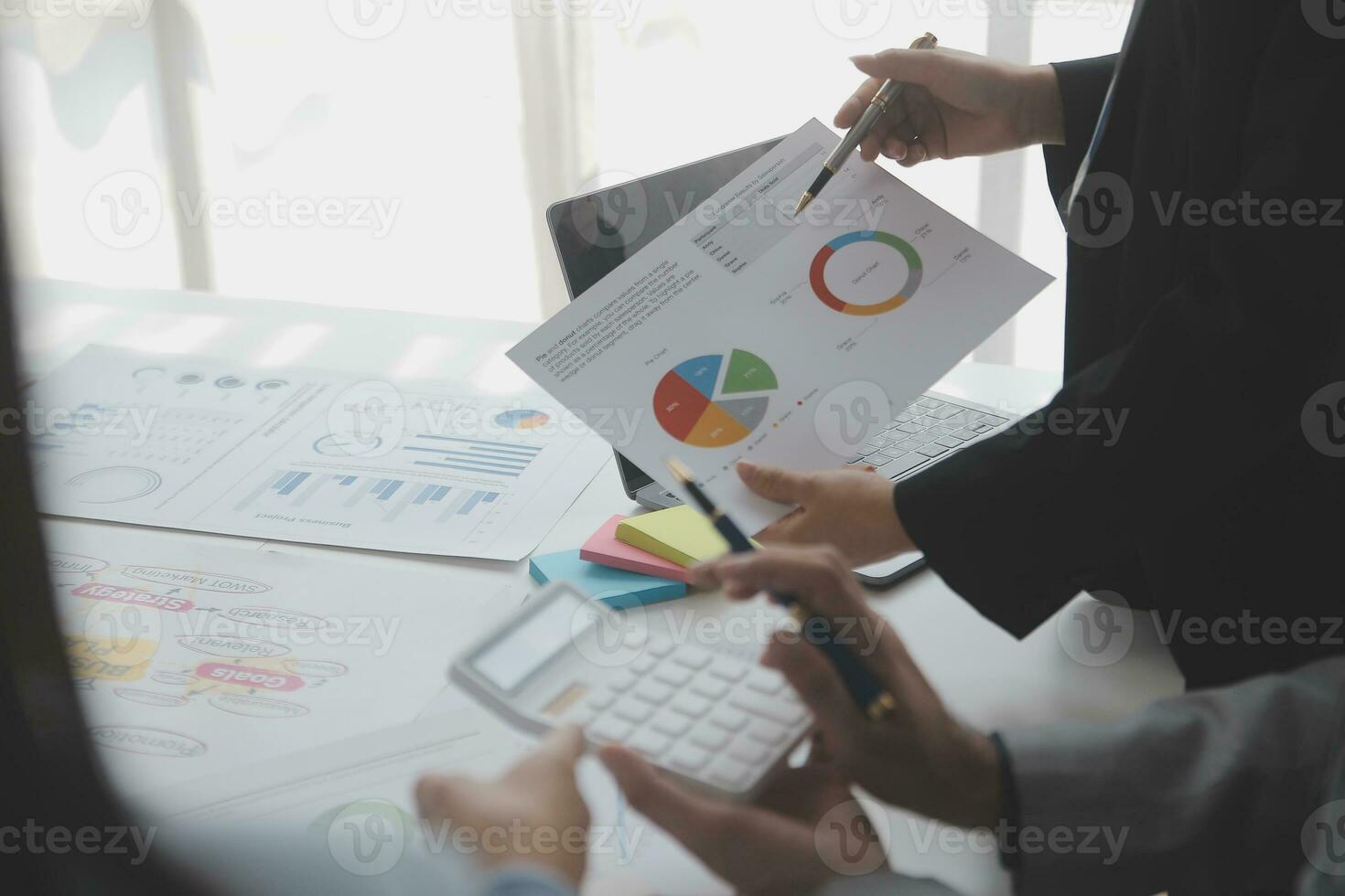 Financial analysts analyze business financial reports on a digital tablet planning investment project during a discussion at a meeting of corporate showing the results of their successful teamwork. photo