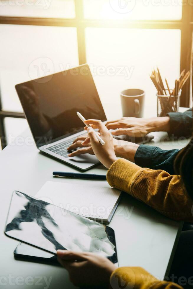 Financial analysts analyze business financial reports on a digital tablet planning investment project during a discussion at a meeting of corporate showing the results of their successful teamwork. photo