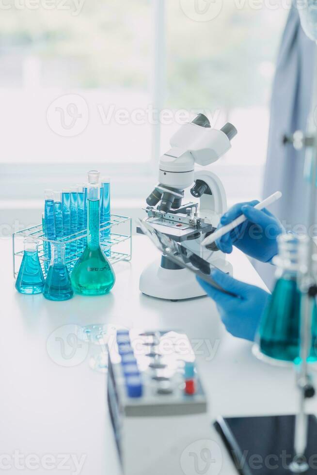 microscope with lab glassware, science laboratory research and development concept photo