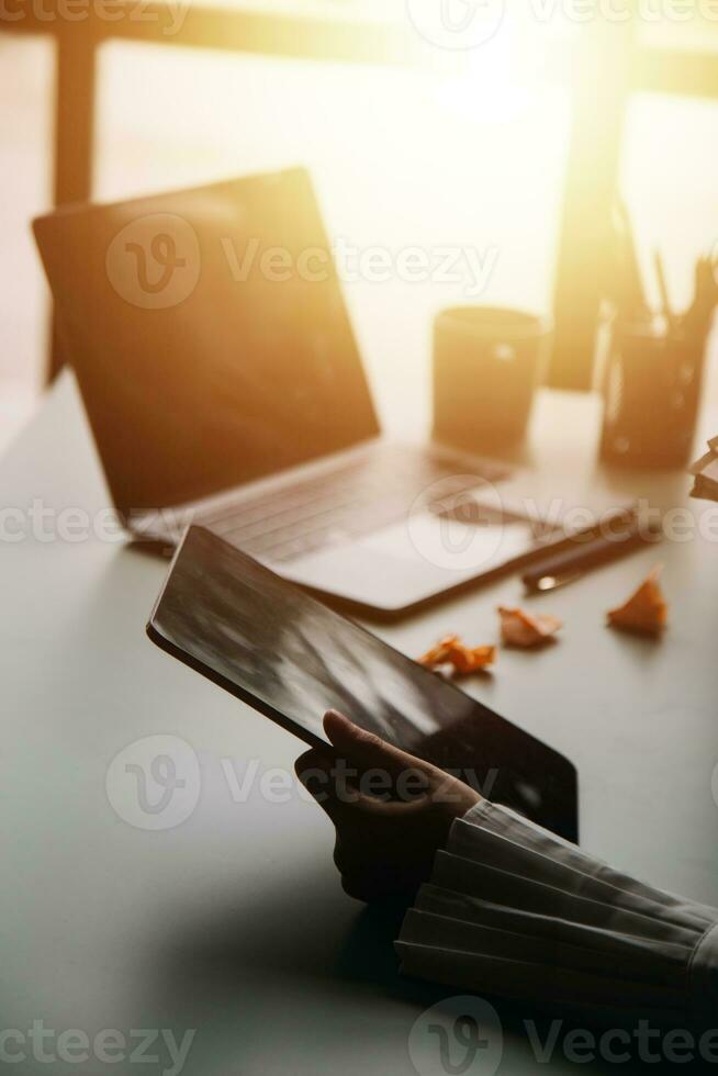 Financial analysts analyze business financial reports on a digital tablet planning investment project during a discussion at a meeting of corporate showing the results of their successful teamwork. photo