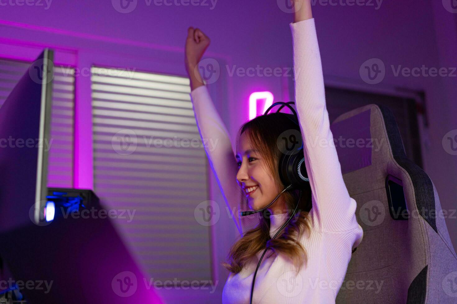 Asian gamer playing online video game winning excited on PC with lighting effect, broadcast streaming live at home. Gamer and E-Sport online gaming technology Championship tournament gamer concept. photo