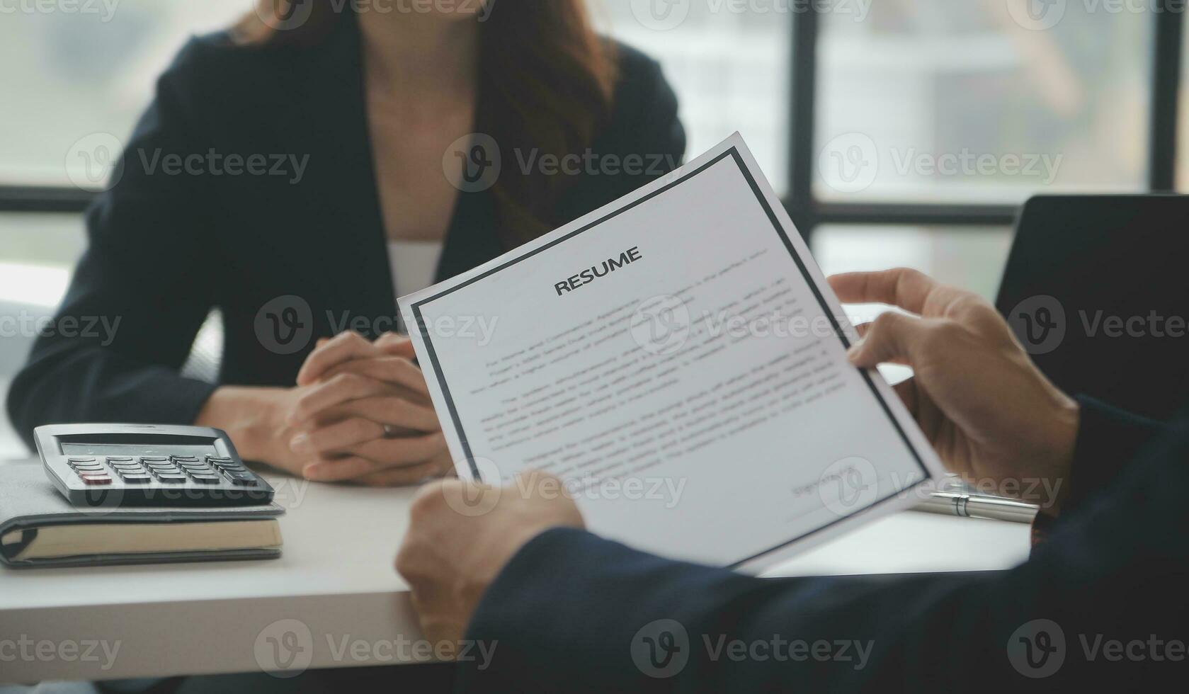 Close up view of job interview in office, focus on resume writing tips, employer reviewing good cv of prepared skilled applicant, recruiter considering application, hr manager making hiring decision photo