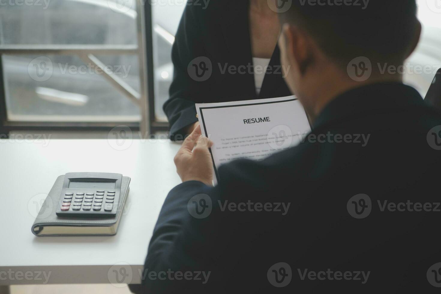 Close up view of job interview in office, focus on resume writing tips, employer reviewing good cv of prepared skilled applicant, recruiter considering application, hr manager making hiring decision photo