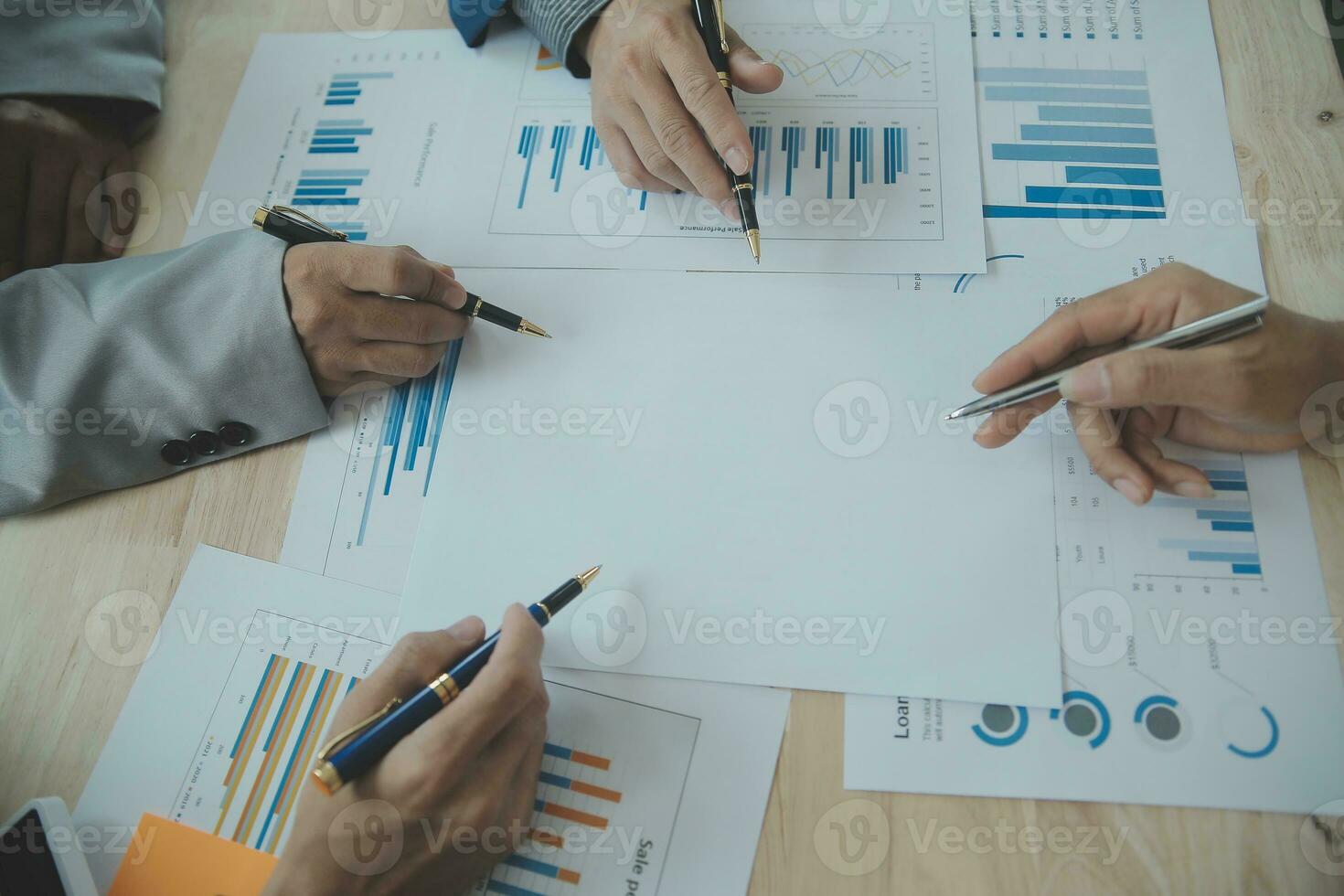 Group of confident business people point to graphs and charts to analyze market data, balance sheet, account, net profit to plan new sales strategies to increase production capacity. photo