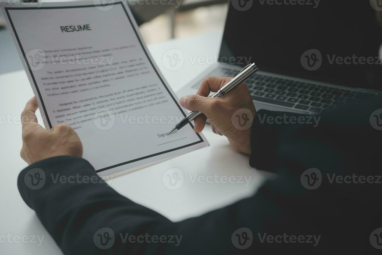 Close up view of job interview in office, focus on resume writing tips, employer reviewing good cv of prepared skilled applicant, recruiter considering application, hr manager making hiring decision photo