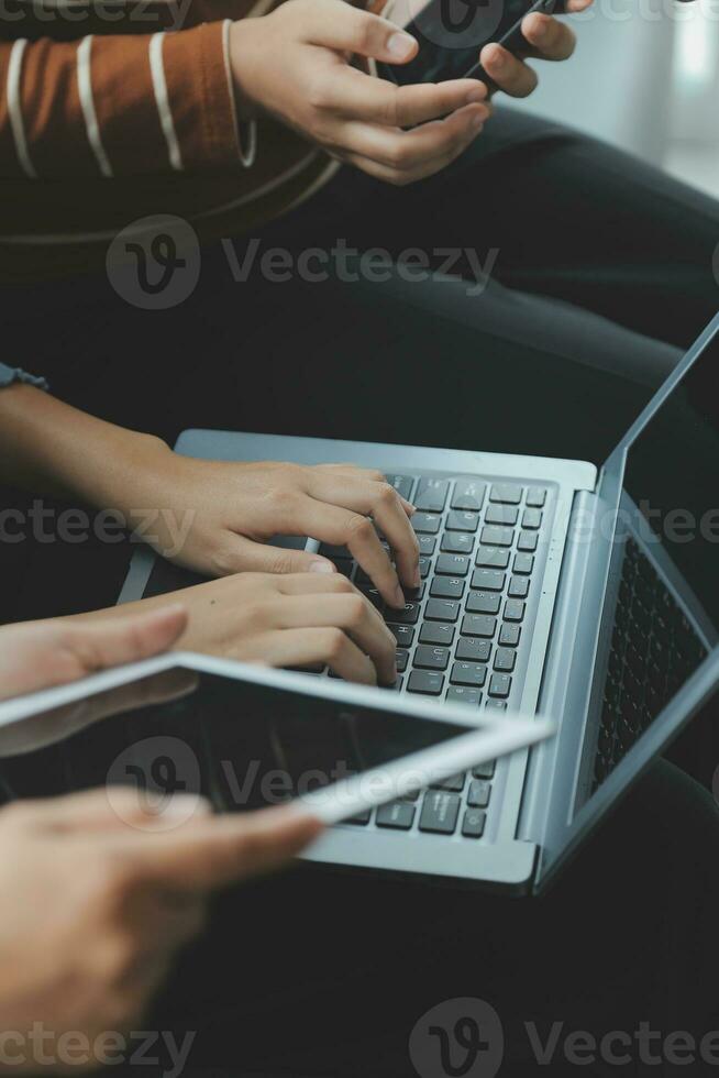 Asian Business woman using calculator and laptop for doing math finance on an office desk, tax, report, accounting, statistics, and analytical research concept photo