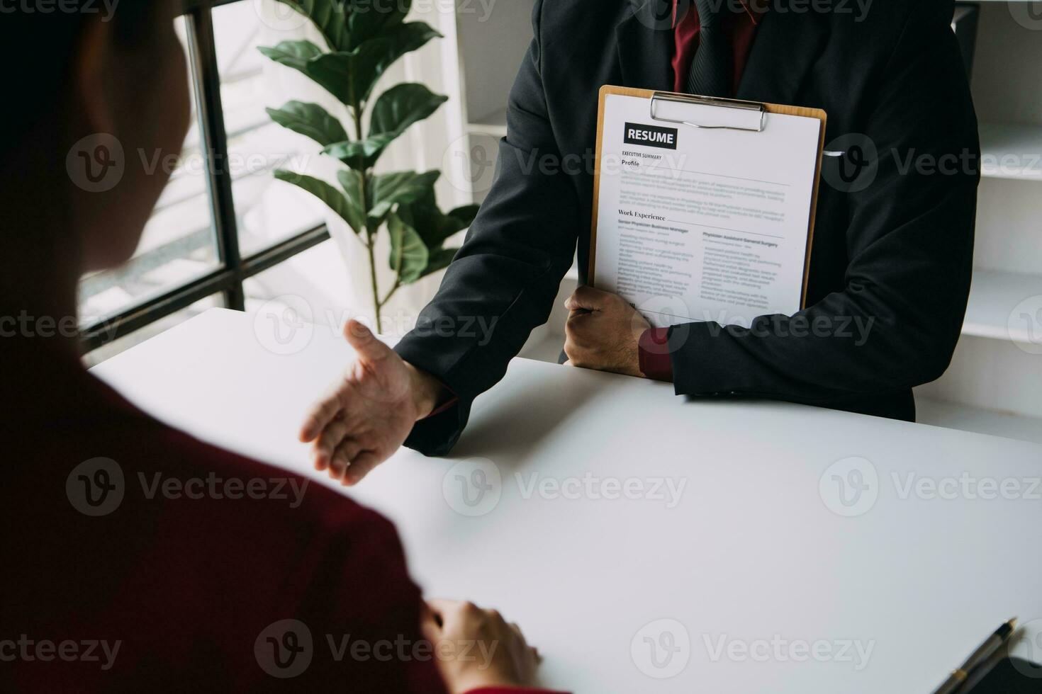 Businessman or job seeker review his resume on his desk before send to finding a new job with pen, necktie, glasses and digital tablet. photo