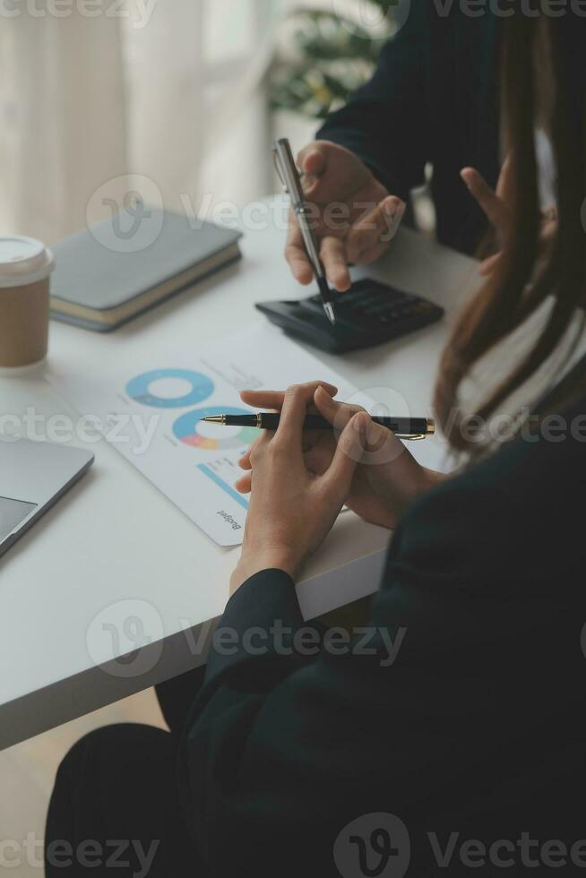 Financial analysts analyze business financial reports on a digital tablet planning investment project during a discussion at a meeting of corporate showing the results of their successful teamwork. photo