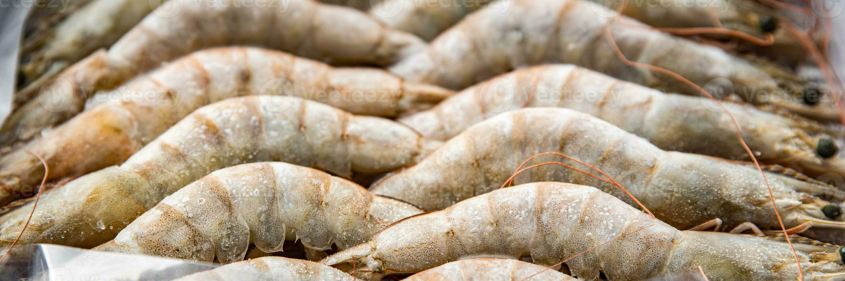 gambas raw frozen in ice big shrimp seafood prawn meal food snack pescatarian diet on the table copy space food background rustic top view keto or paleo photo