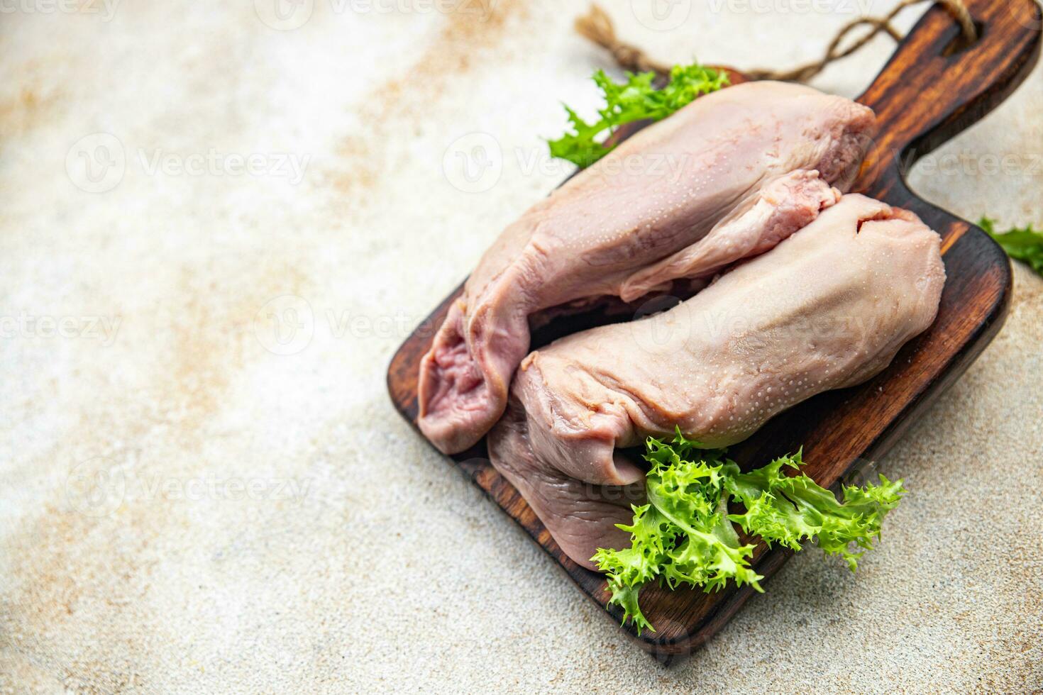raw tongue pork meat healthy meal food snack on the table copy space food background rustic top view keto or paleo diet photo