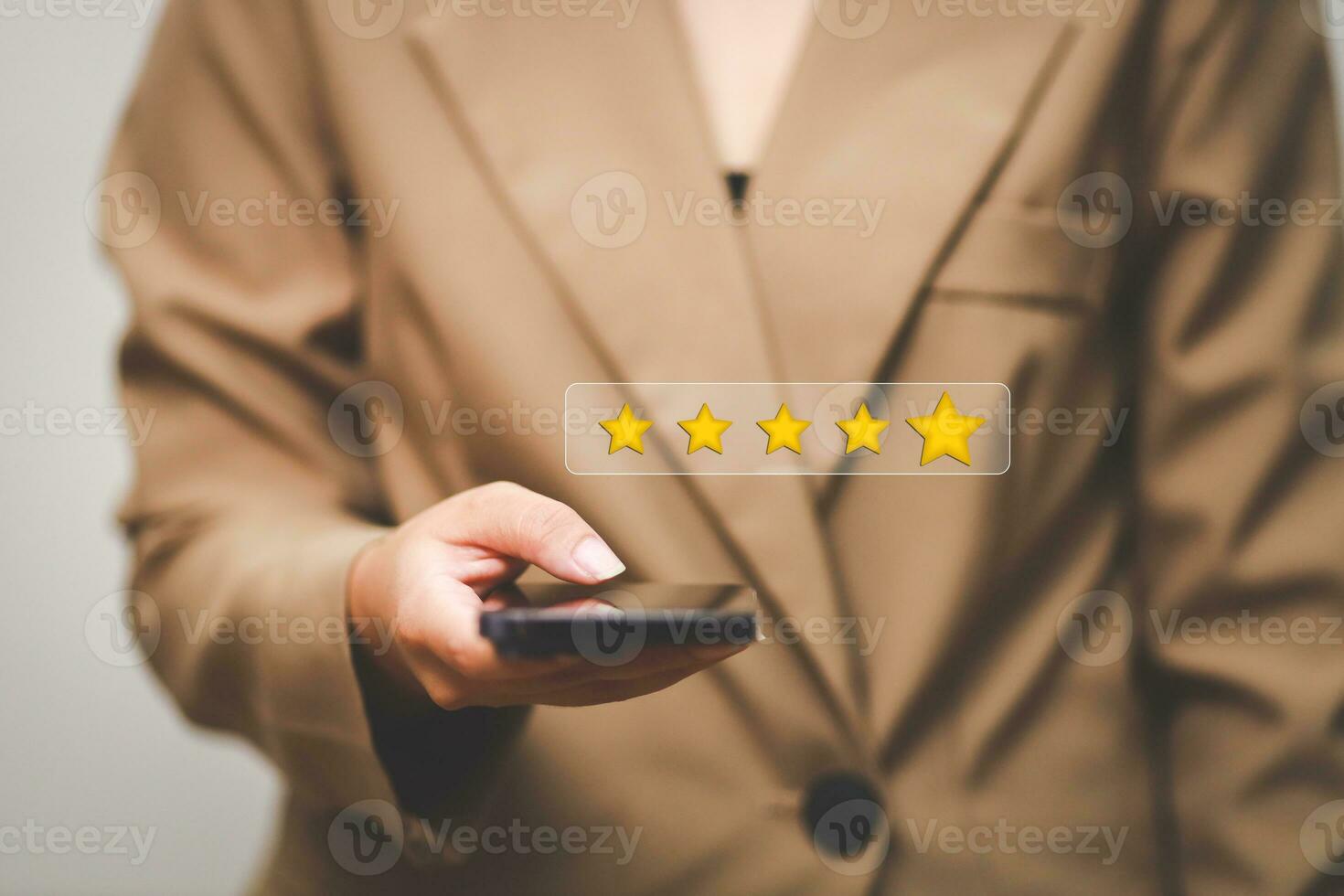 Customer pressing satisfaction with gold five star rating feedback icon and press level excellent rank for giving best score point to review the service , experience success business rate  concept. photo