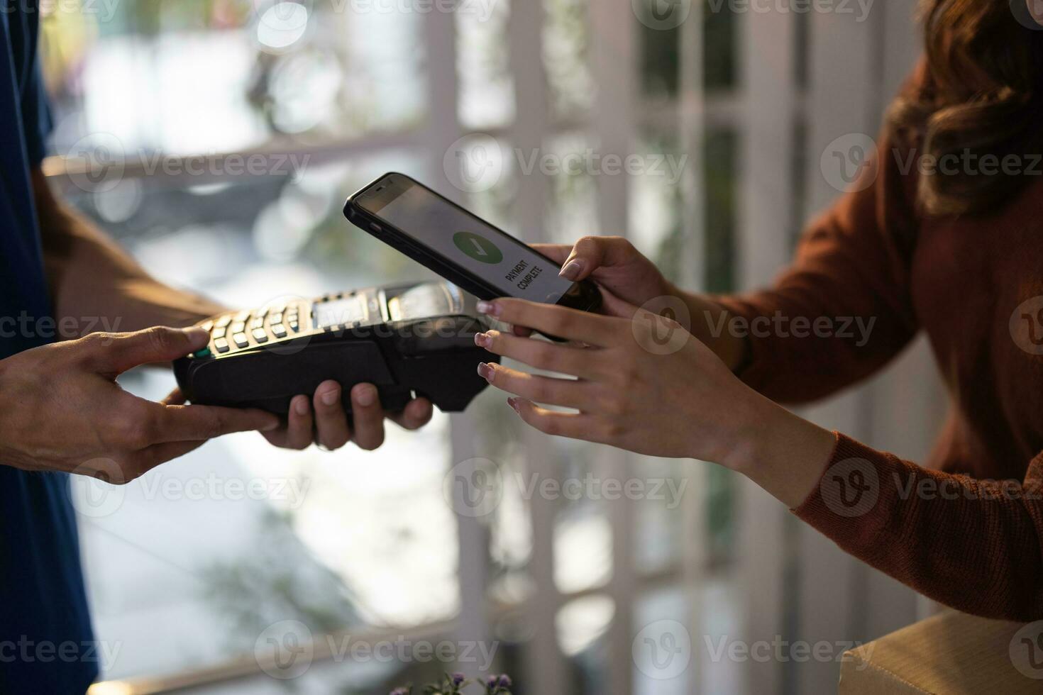 Female vase seller processes orders, including delivery payments, with smartphone and quick response code before sending items to customers. Small business owner work and coordinate with carrier. photo