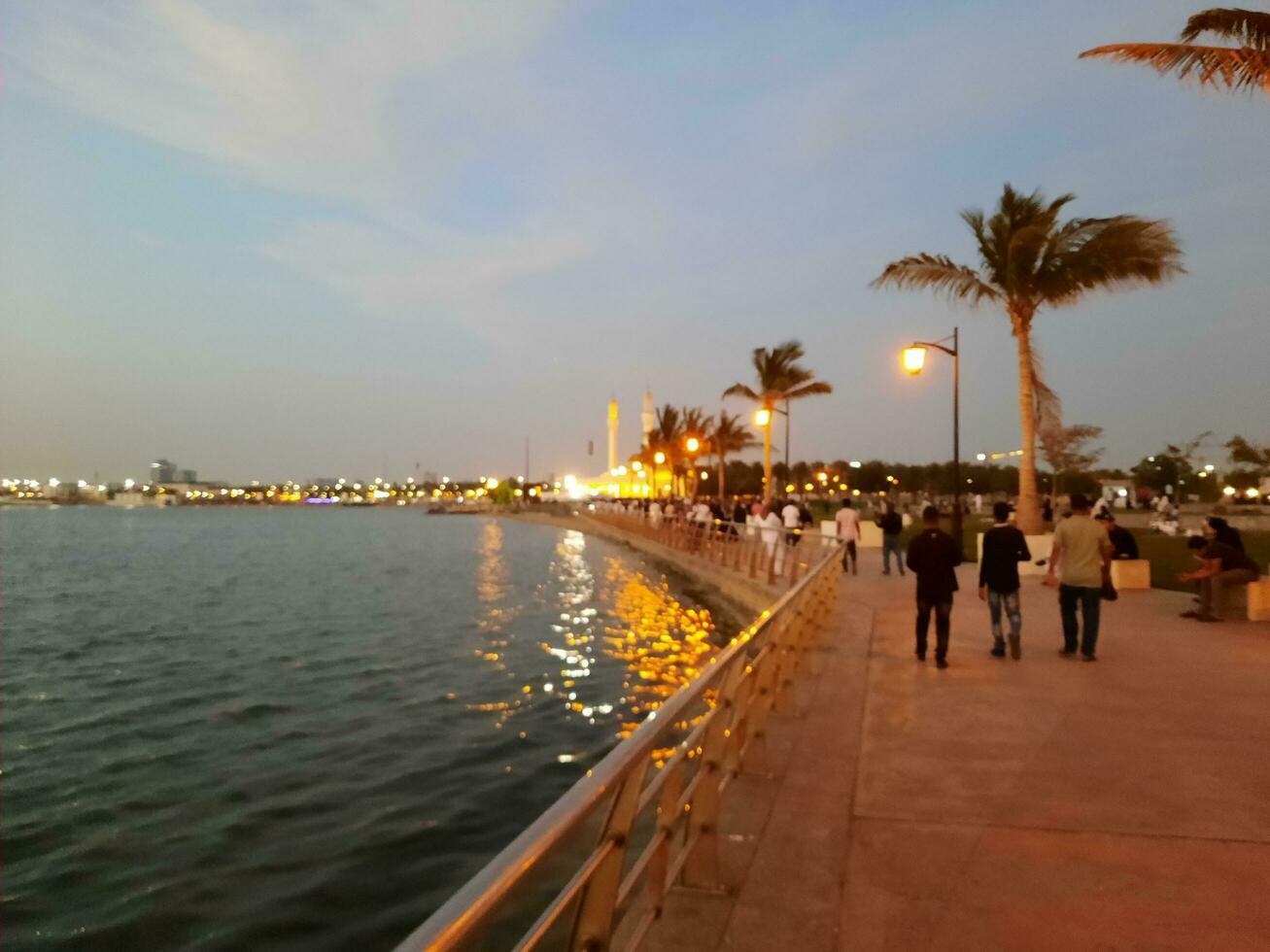 Jeddah, Saudi Arabia, April 2023 - Beautiful evening view of Jeddah Corniche. A large number of people are seen in the park of Jeddah Corniche. photo