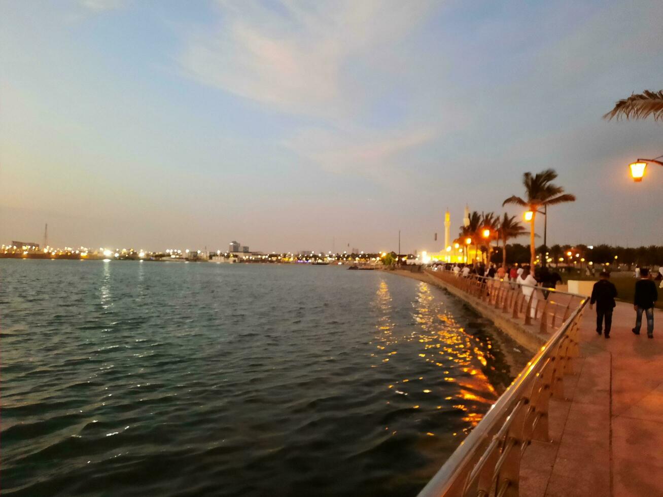 Jeddah, Saudi Arabia, April 2023 - Beautiful evening view of Jeddah Corniche. A large number of people are seen in the park of Jeddah Corniche. photo