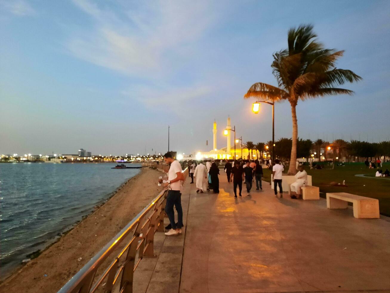 Jeddah, Saudi Arabia, April 2023 - Beautiful evening view of Jeddah Corniche. A large number of people are seen in the park of Jeddah Corniche. photo