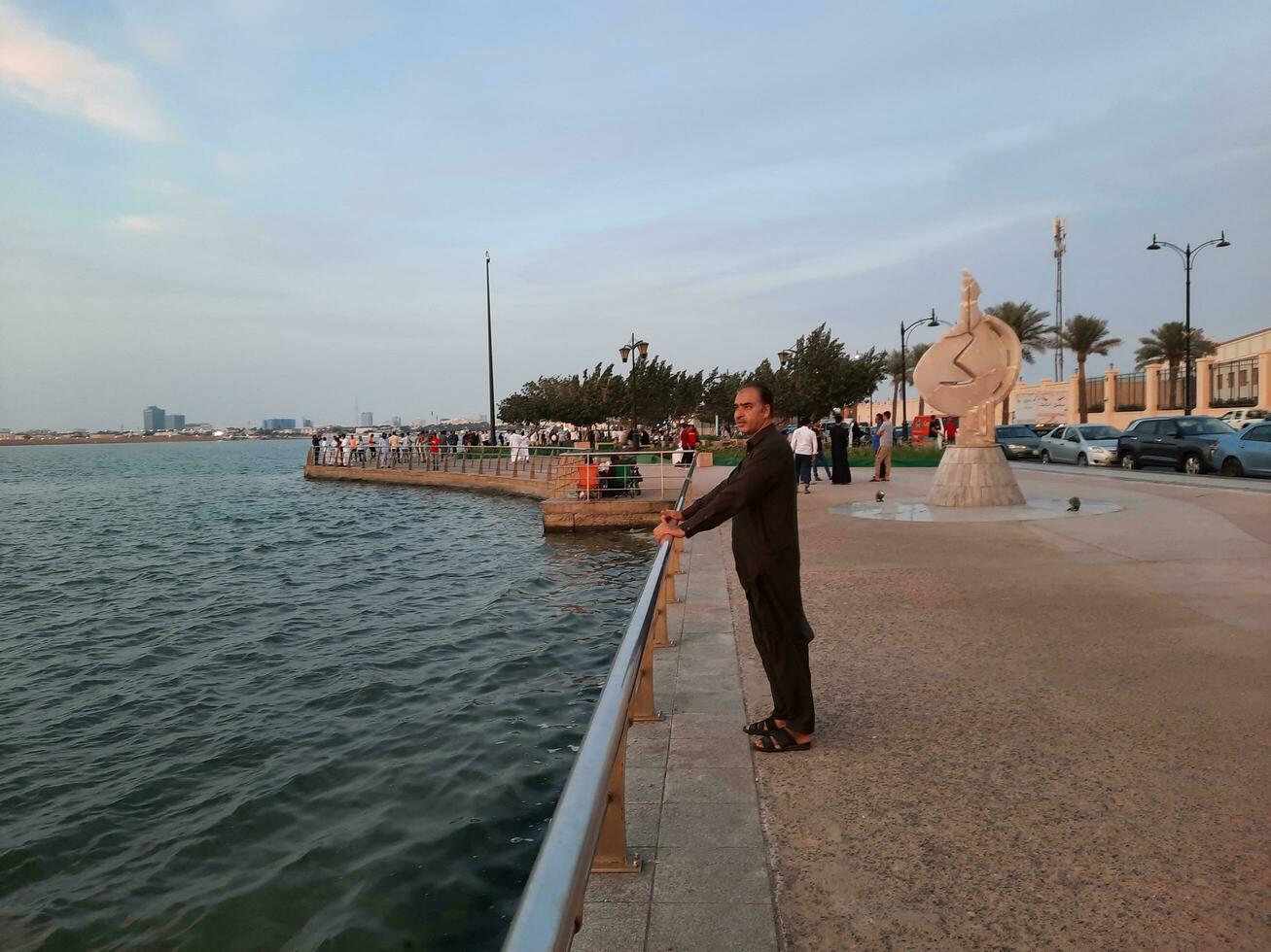 Jeddah, Saudi Arabia, April 2023 - Beautiful evening view of Jeddah Corniche. A large number of people are seen in the park of Jeddah Corniche. photo