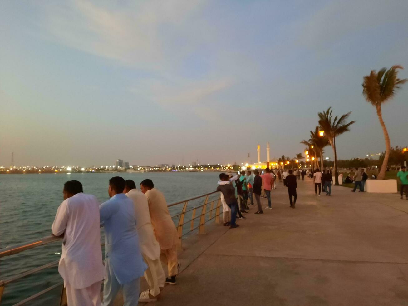 Jeddah, Saudi Arabia, April 2023 - Beautiful evening view of Jeddah Corniche. A large number of people are seen in the park of Jeddah Corniche. photo