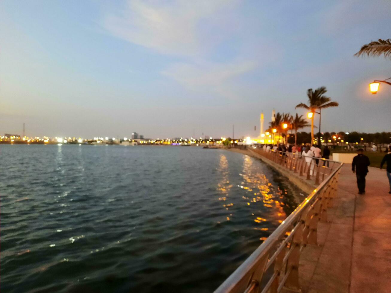 Jeddah, Saudi Arabia, April 2023 - Beautiful evening view of Jeddah Corniche. A large number of people are seen in the park of Jeddah Corniche. photo
