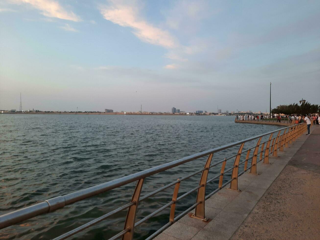 Jeddah, Saudi Arabia, April 2023 - Beautiful evening view of Jeddah Corniche. A large number of people are seen in the park of Jeddah Corniche. photo