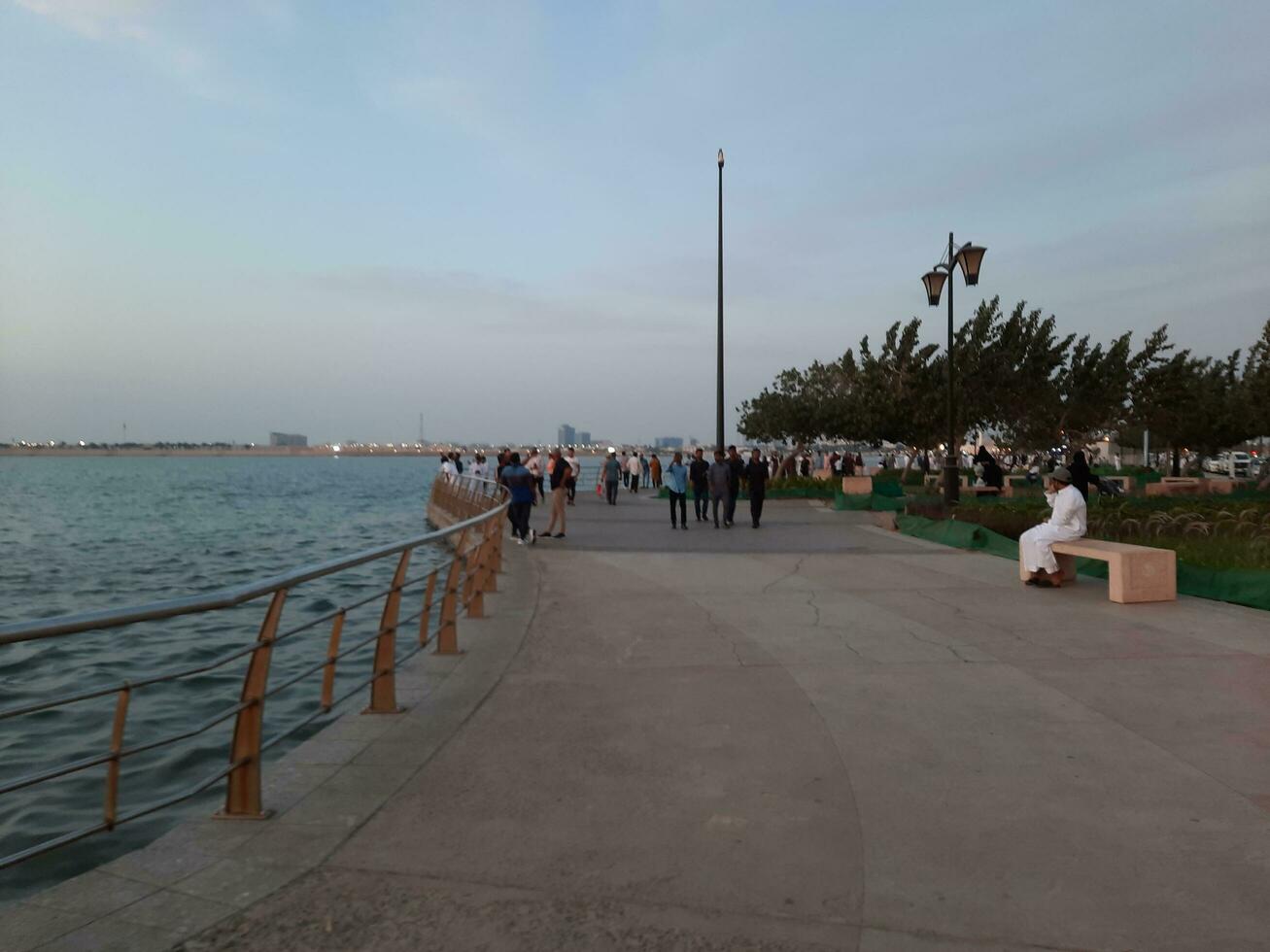 Jeddah, Saudi Arabia, April 2023 - Beautiful evening view of Jeddah Corniche. A large number of people are seen in the park of Jeddah Corniche. photo