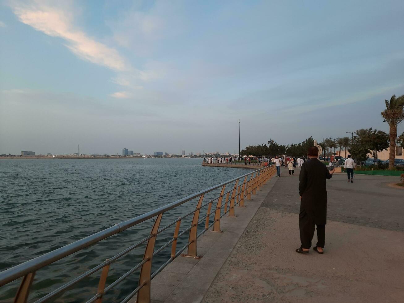 Jeddah, Saudi Arabia, April 2023 - Beautiful evening view of Jeddah Corniche. A large number of people are seen in the park of Jeddah Corniche. photo