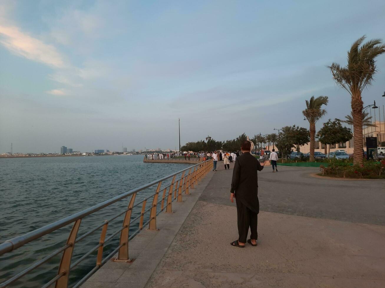Jeddah, Saudi Arabia, April 2023 - Beautiful evening view of Jeddah Corniche. A large number of people are seen in the park of Jeddah Corniche. photo