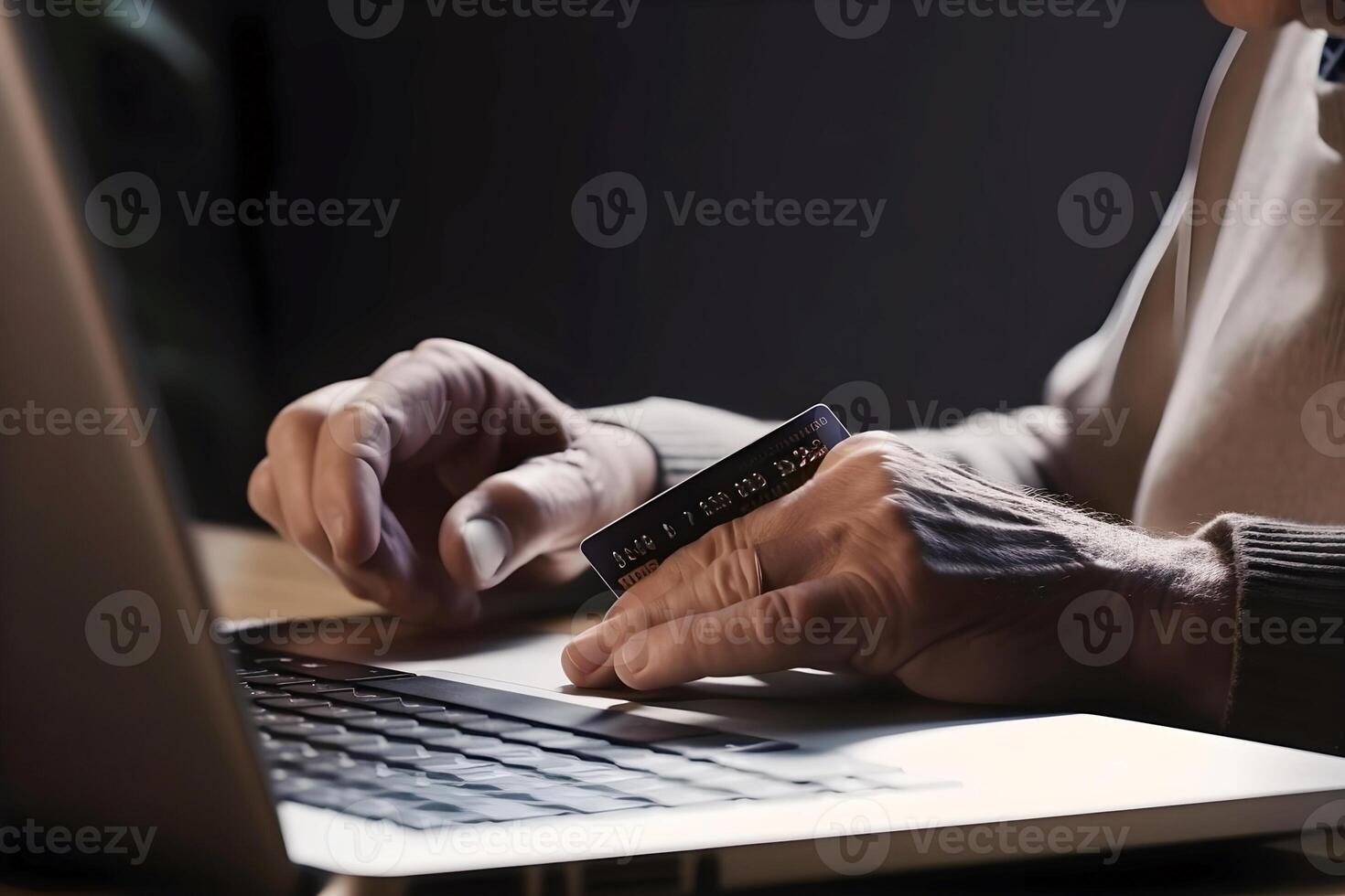 content, hands of an elderly man in the frame, makes purchases online using a laptop. Bank card in hand, shopping online photo