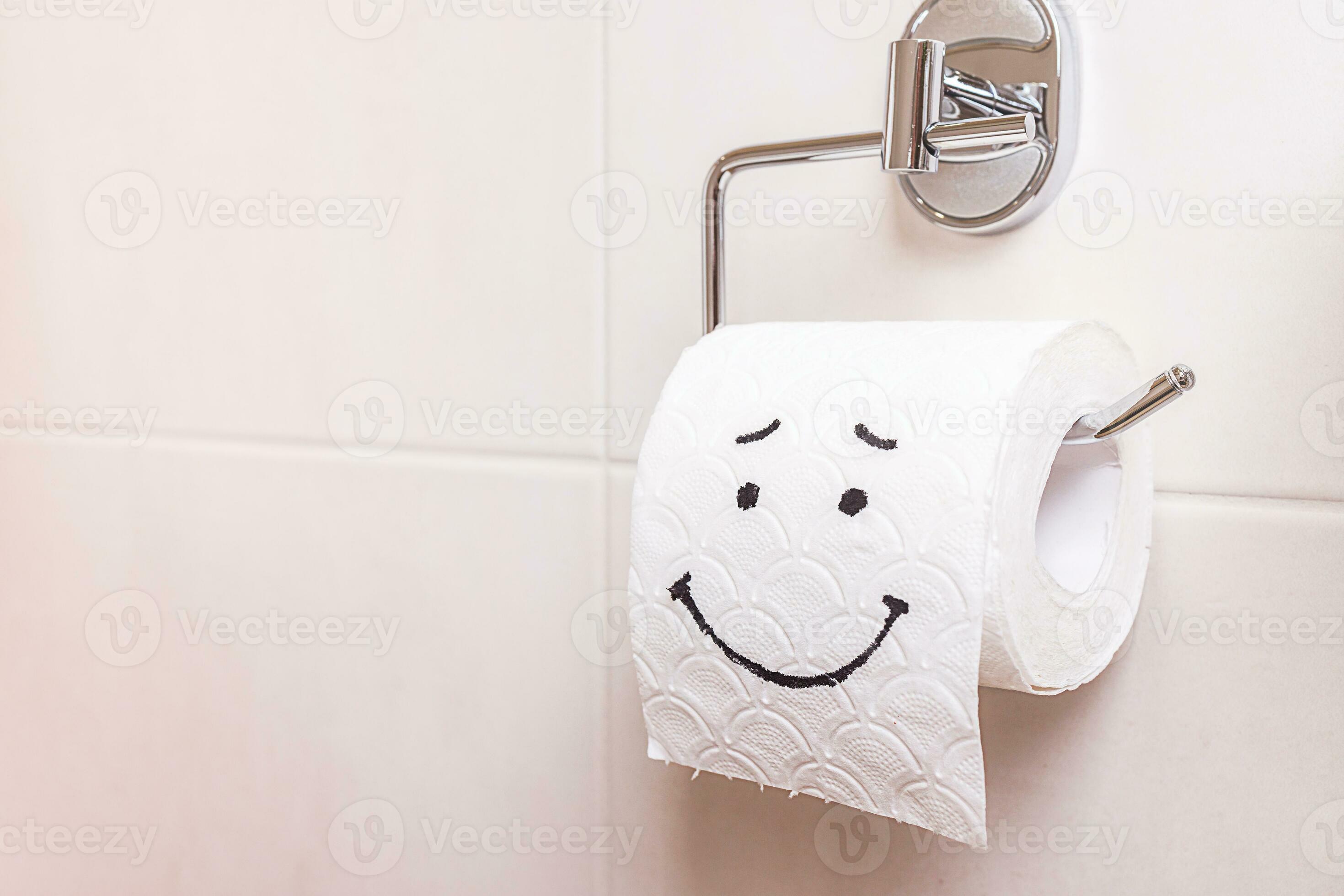 closeup, a roll of toilet paper with a painted sad face stands on the