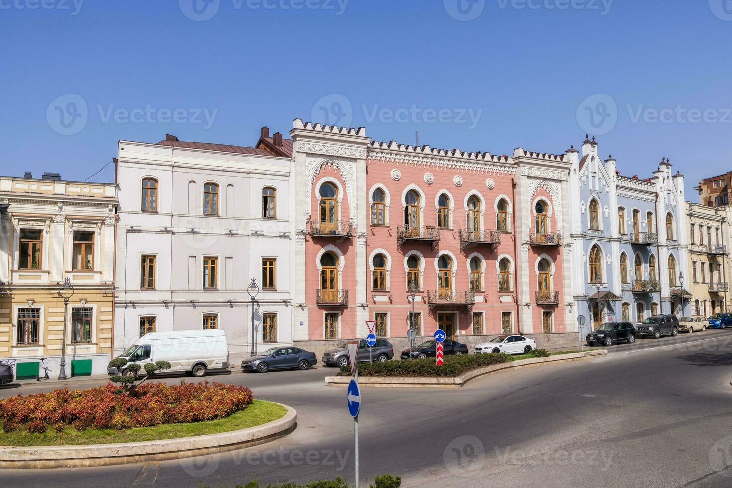 City street with different houses in summer. Big city urban life concept background. photo