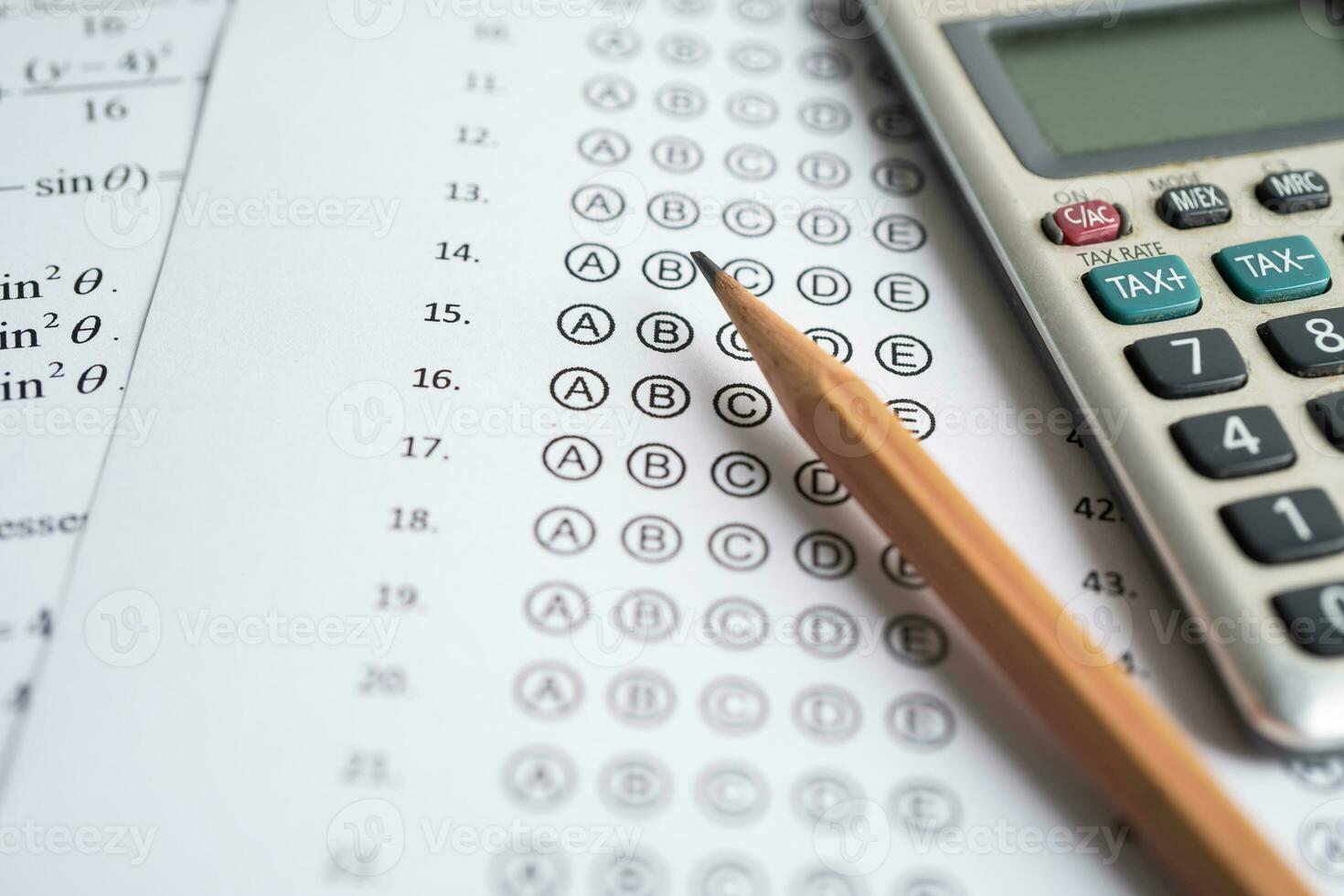 Answer sheets with pencil and calculator to drawing fill select choice, education concept. photo