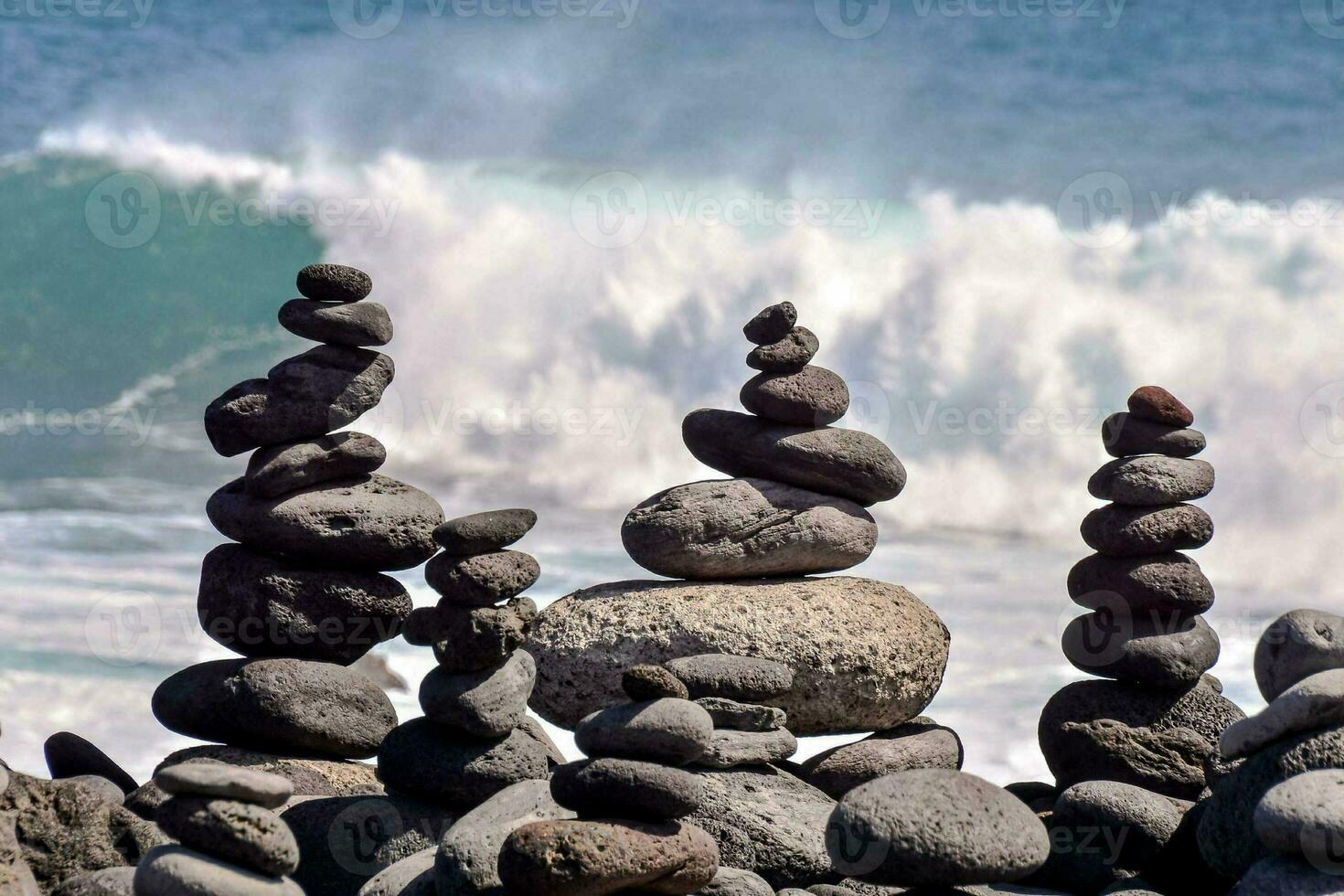 Stone pyramids on the beach photo