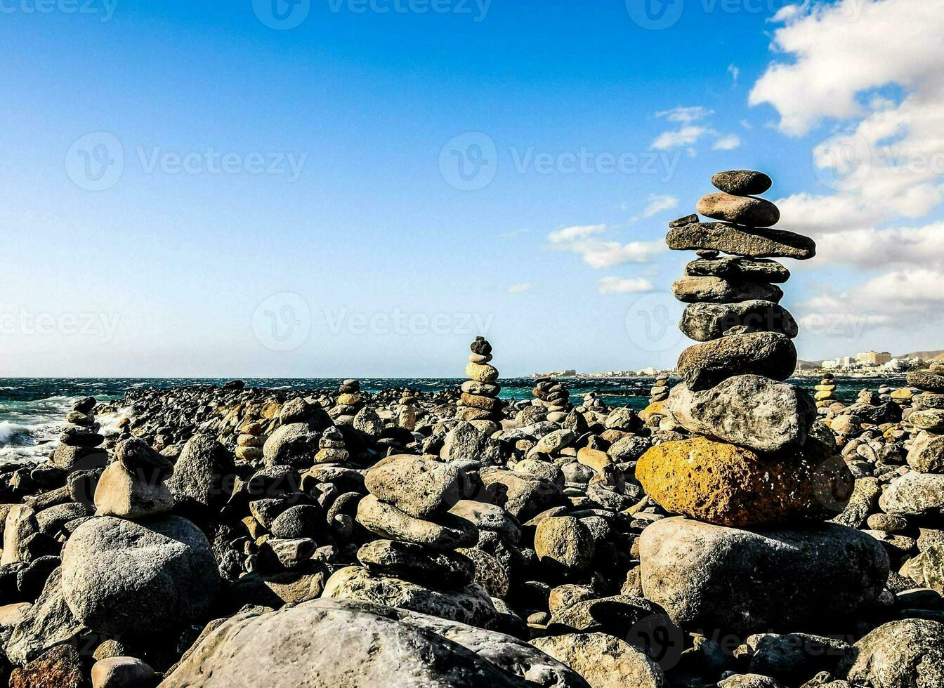 Stone pyramids on the beach photo