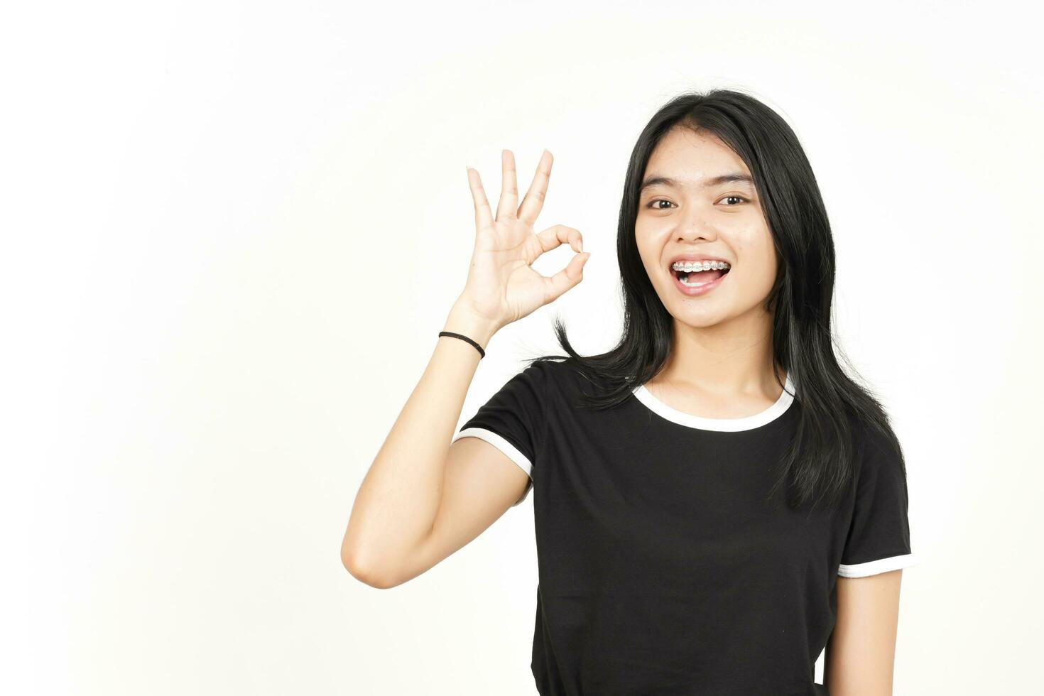 Smiling and Showing OK Sign Of Beautiful Asian Woman Isolated On White Background photo