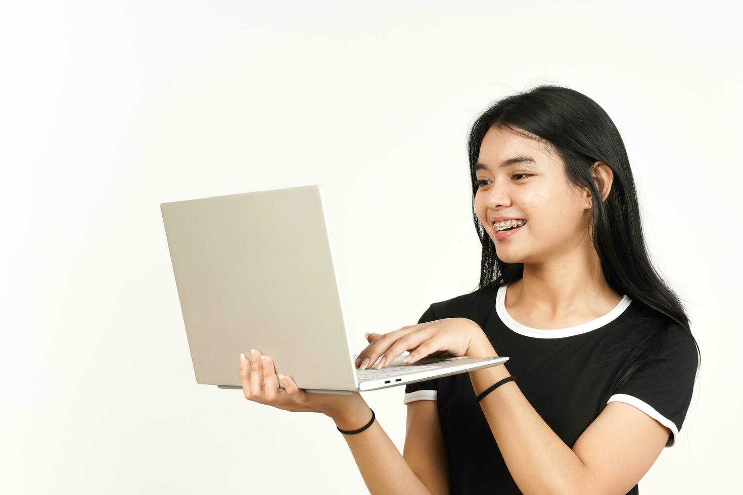 Smiling and Using Laptop Of Beautiful Asian Woman Isolated On White Background photo