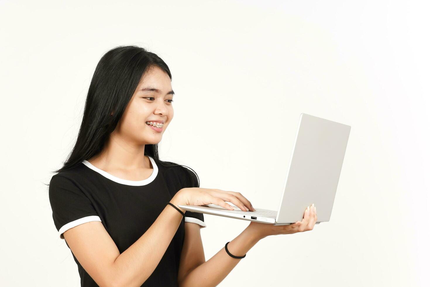 Smiling and Using Laptop Of Beautiful Asian Woman Isolated On White Background photo