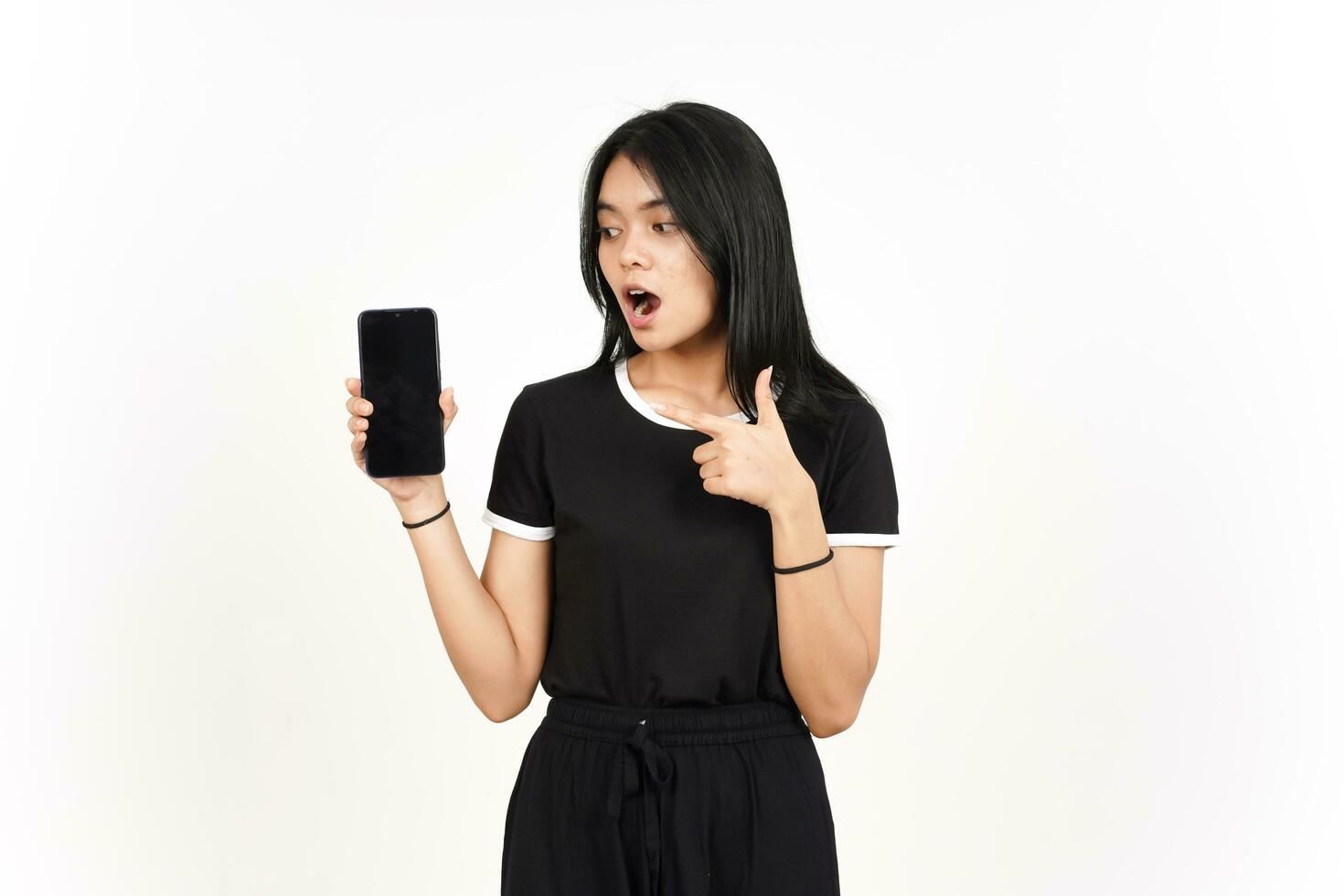 Showing blank smartphone screen with shocked face Of Beautiful Asian Woman Isolated On White photo