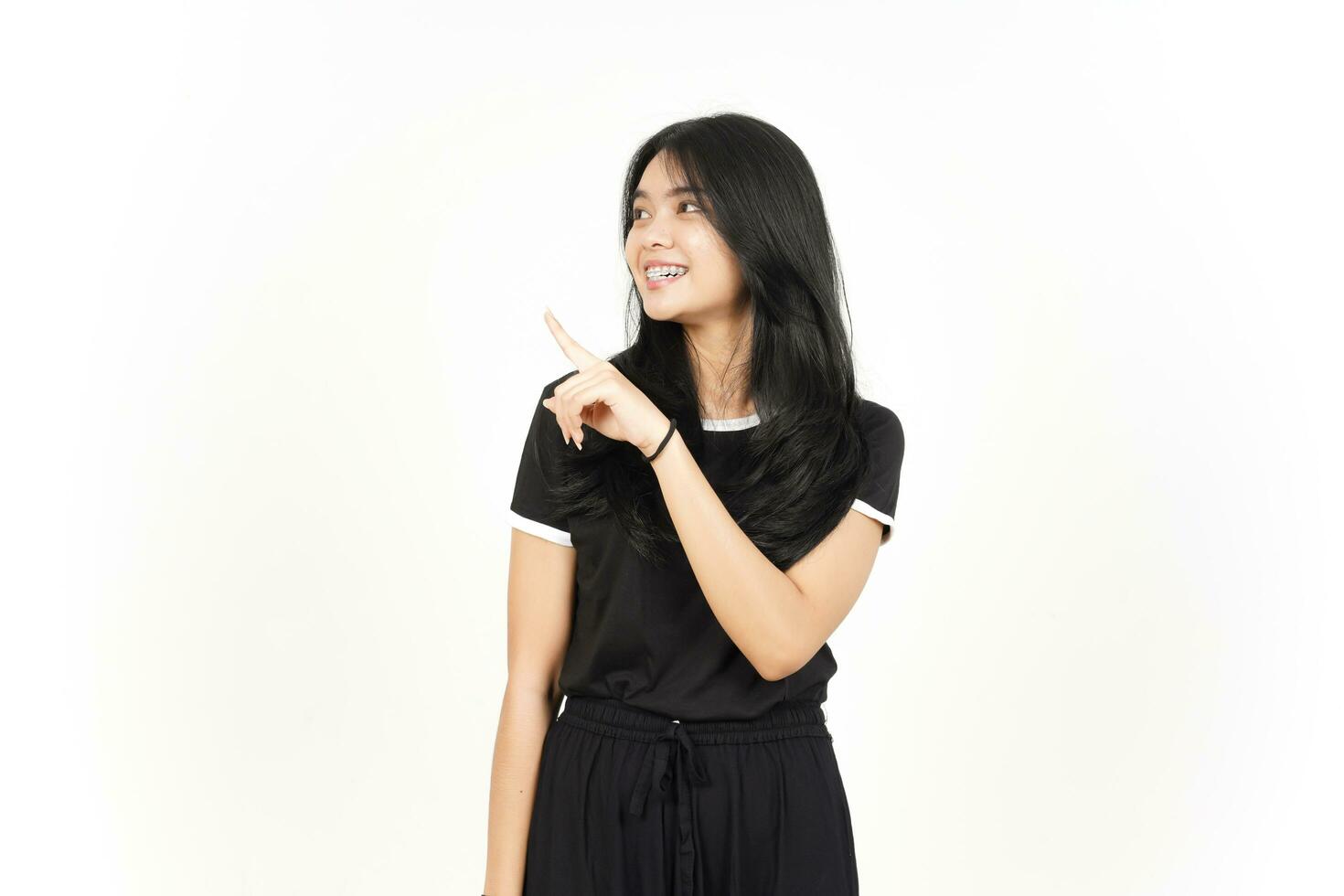 Showing Product and Pointing Side using forefinger Of Beautiful Asian Woman Isolated On White photo