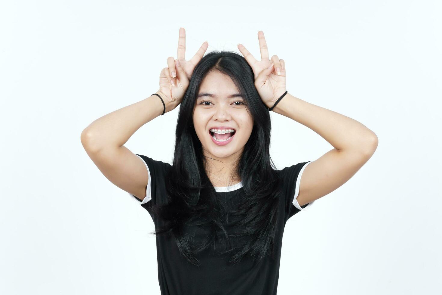 Showing Peace Sign or Finger V Sign Of Beautiful Asian Woman Isolated On White Background photo
