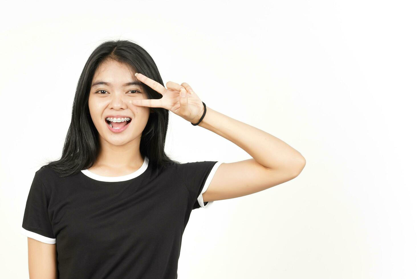 Showing Peace Sign on Eye Of Beautiful Asian Woman Isolated On White Background photo