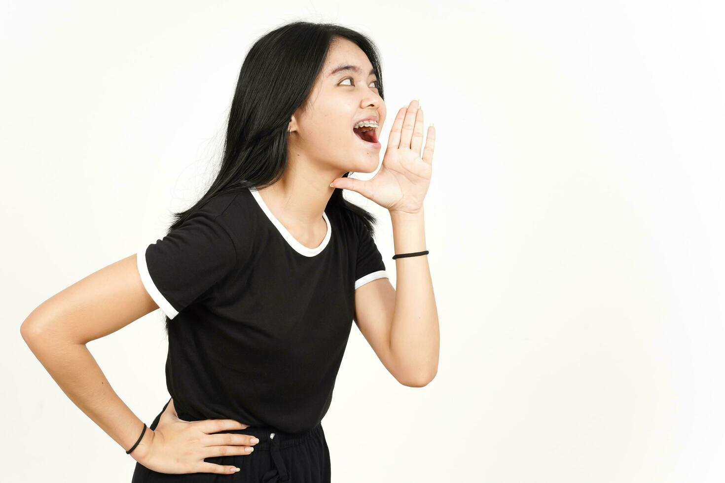 Making Announcement with hands over mouth Of Beautiful Asian Woman Isolated On White Background photo