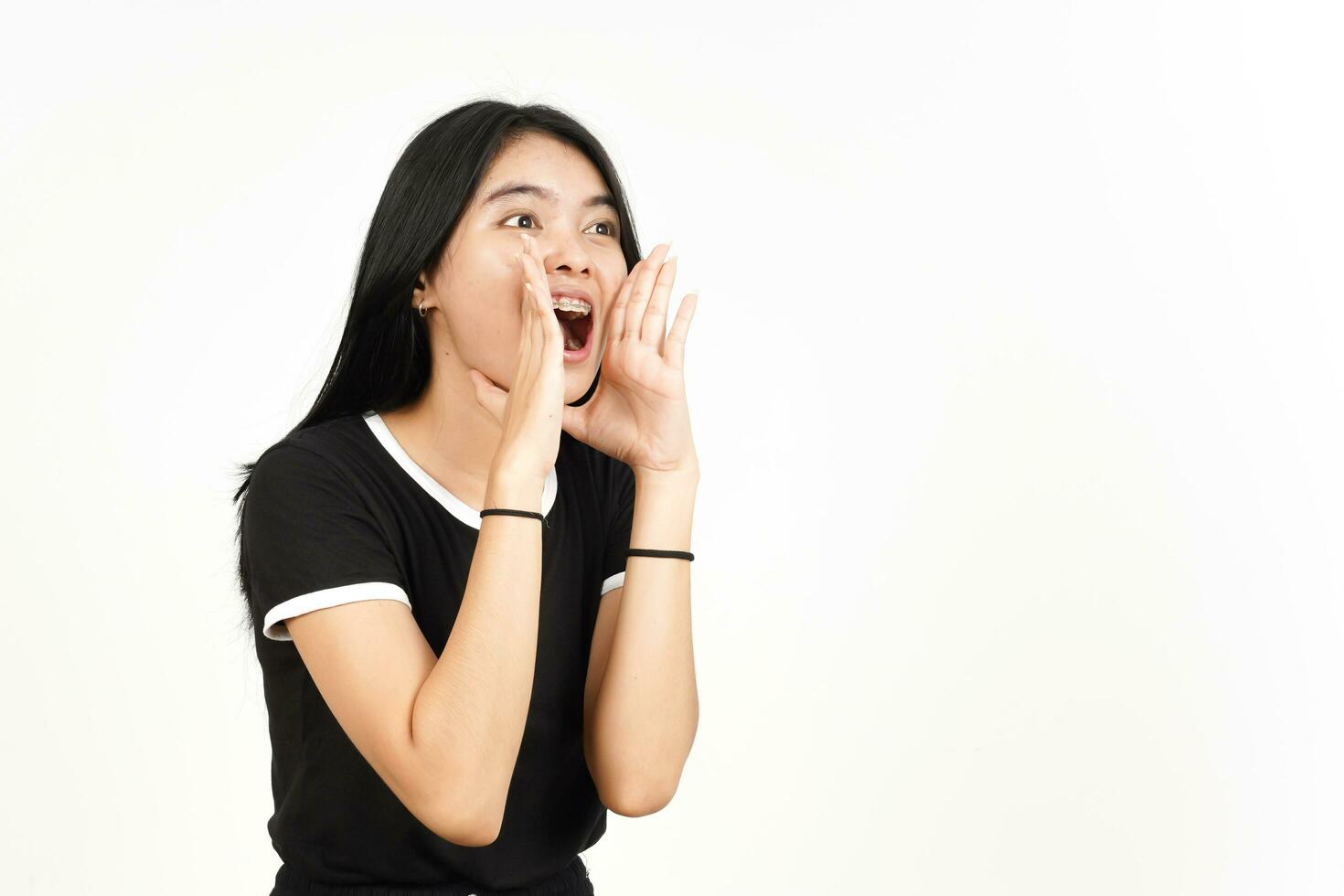 Making Announcement with hands over mouth Of Beautiful Asian Woman Isolated On White Background photo