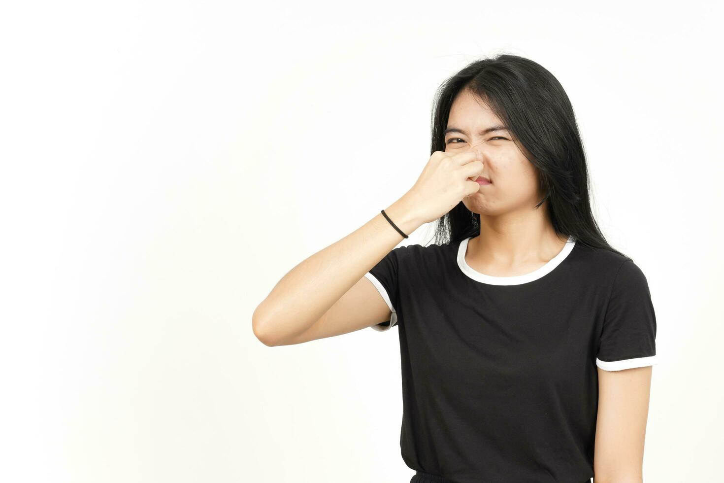 Smelling something stinky and disgusting of Beautiful Asian Woman Isolated On White Background photo